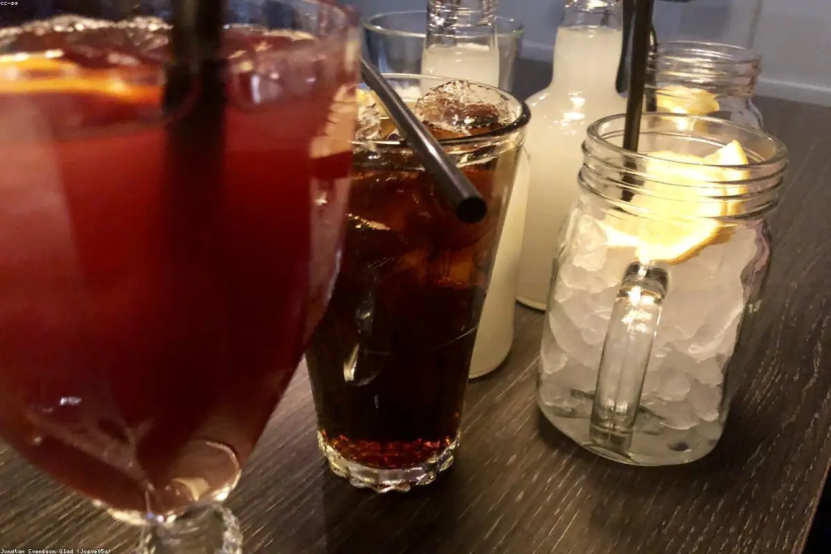 Craft cocktail garnished with a flamed citrus peel