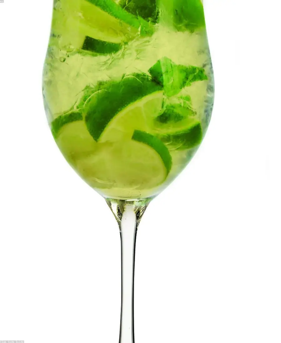Close-up of a bartender placing a herb garnish on a drink
