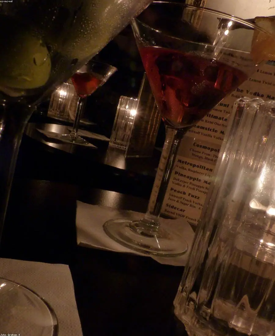 A martini being strained into a chilled coupe glass